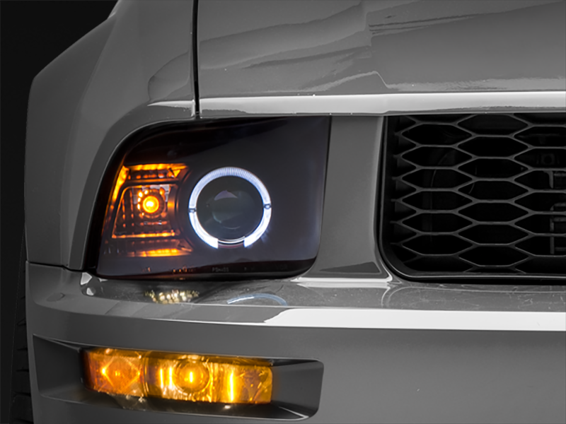 RAXIOM 05-09 Ford Mustang Halogen 2010 Style LED Halo Headlights-Blk Hsng(Clear Lens/Excludes GT500)