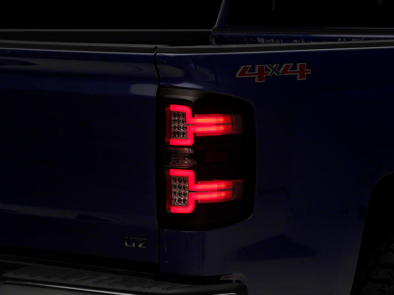 RAXIOM 14-18 Chevrolet Silverado 1500 LED Taillights w/ SEQL Turn Signals- Blk Housing (Clear Lens)