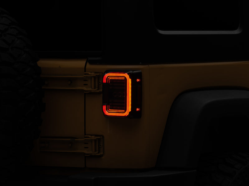 RAXIOM 07-18 Jeep Wrangler JK Axial Series LED Halo Tail Lights- Black Housing (Dark Smoked Lens)