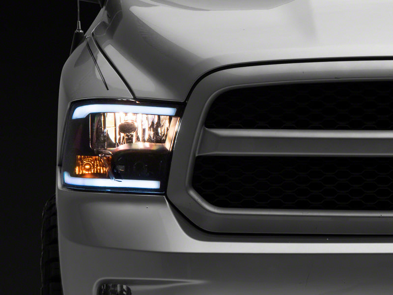 RAXIOM 09-18 Dodge RAM 1500/2500/3500 Axial Headlights w/ SEQL LED Bar- Blk Housing (Clear Lens)