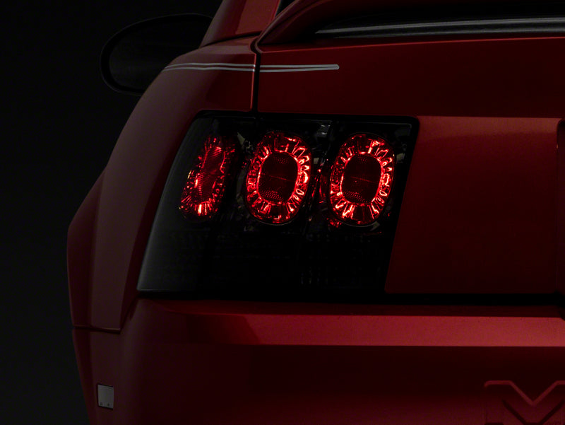 RAXIOM 99-04 Ford Mustang Axial Series Altezza Style Tail Lights- Blk Housing (Smoked Lens)