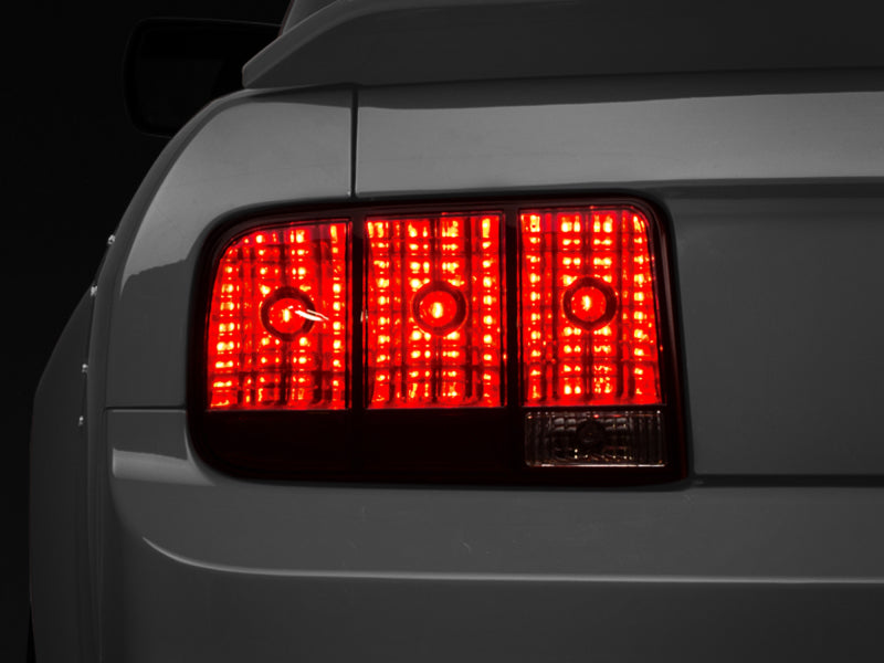 RAXIOM 05-09 Ford Mustang Tail Lights- Black Housing (Smoked Lens)